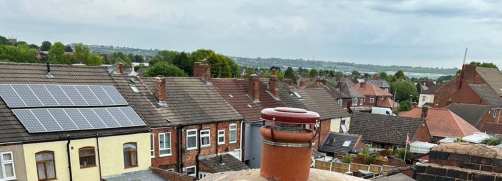 This is a photo taken from a roof which is being repaired. It shows a street of houses, and their roofs